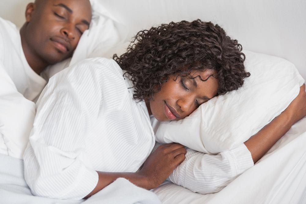 couple sleeping in bed soundly | sleep apnea dentist bellevue