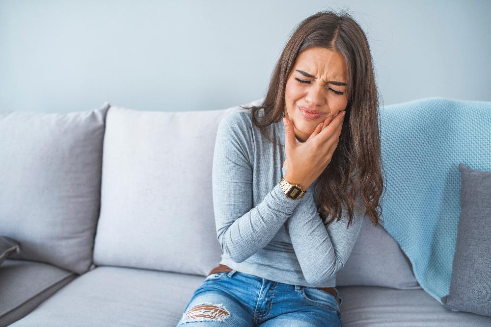 woman in pain holding jaw | sedation dentist bellevue