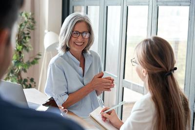 two women talking inside | bone grafting bellevue