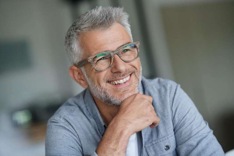 man with grey hair smiling | dental implants bellevue tn